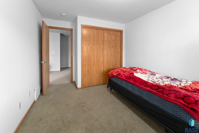 bedroom with a closet and light colored carpet