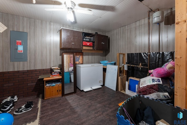 interior space featuring refrigerator, electric panel, and ceiling fan