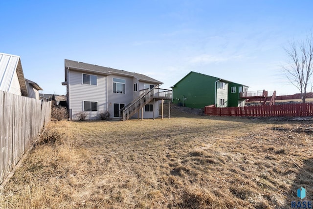 back of house with a yard and a deck