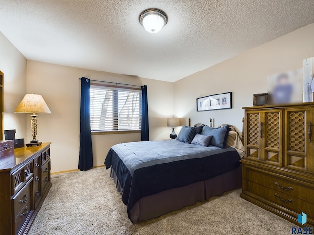 carpeted bedroom featuring a textured ceiling