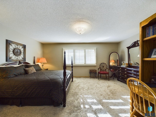 bedroom featuring a textured ceiling and carpet floors