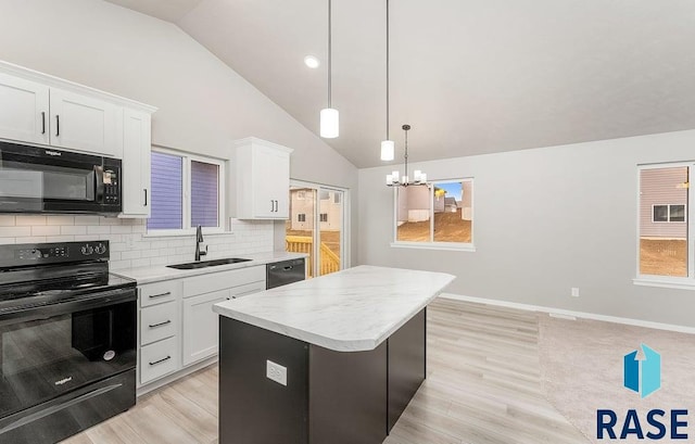 kitchen with sink, black appliances, a center island, white cabinetry, and hanging light fixtures