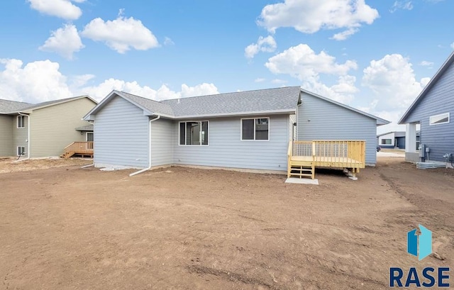 back of property with a wooden deck