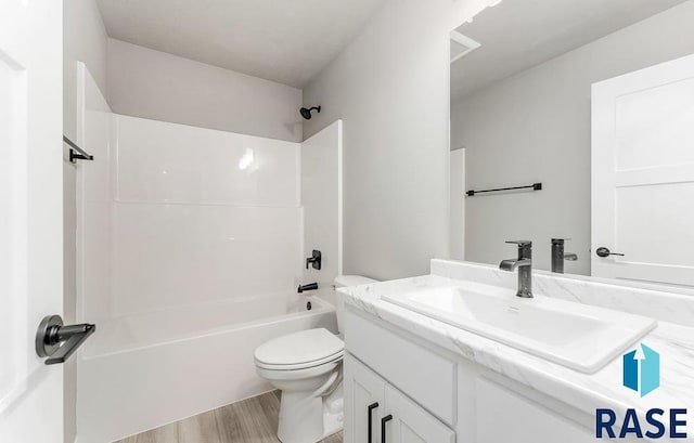 full bathroom featuring hardwood / wood-style floors, vanity, toilet, and shower / tub combination