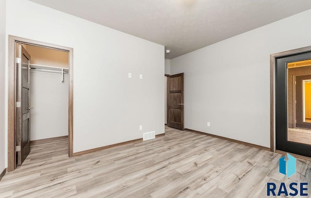 1220 N Rose Ave, Tea, SD 57064 - unfurnished bedroom featuring light wood-type flooring and a closet