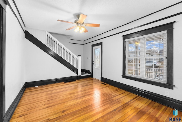 foyer with hardwood / wood-style floors and ceiling fan