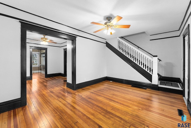 unfurnished living room with ceiling fan and hardwood / wood-style flooring