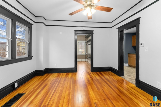 spare room with ceiling fan and light hardwood / wood-style flooring