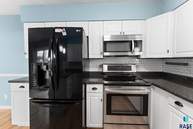 kitchen with appliances with stainless steel finishes, light wood-type flooring, tasteful backsplash, and white cabinetry