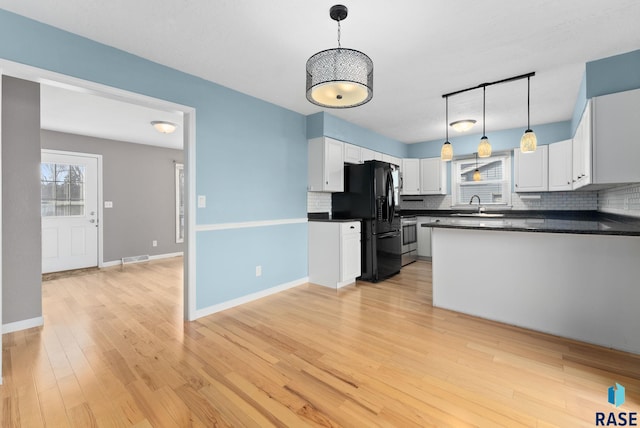 kitchen featuring decorative light fixtures, white cabinetry, and black refrigerator with ice dispenser