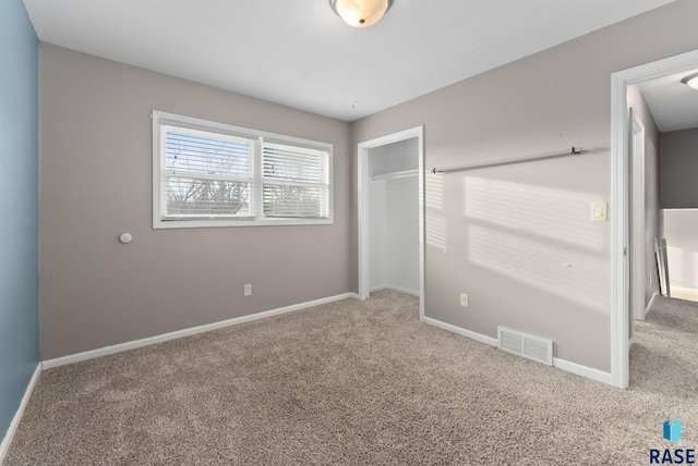 unfurnished bedroom featuring a closet and carpet