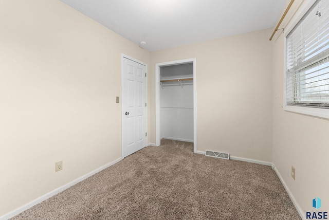 unfurnished bedroom with carpet flooring and a closet