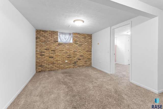 basement featuring a textured ceiling and carpet floors