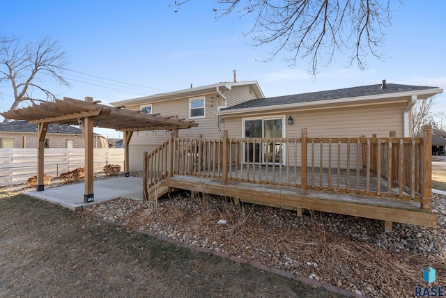 rear view of house featuring a pergola, a patio, and a wooden deck