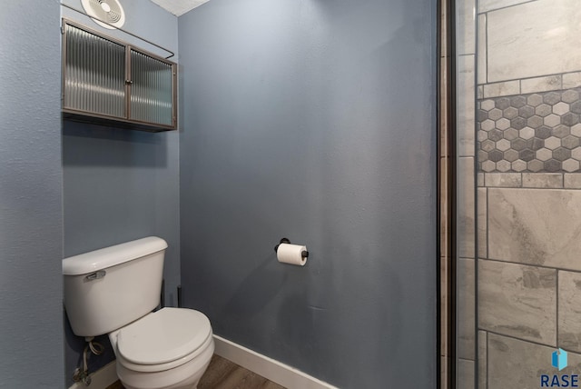 bathroom featuring toilet and wood-type flooring