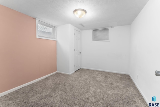 carpeted spare room with a textured ceiling