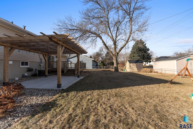 view of yard with a pergola, a shed, central AC unit, and a patio area