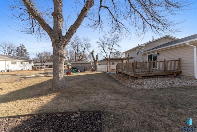 view of yard with a playground and a wooden deck