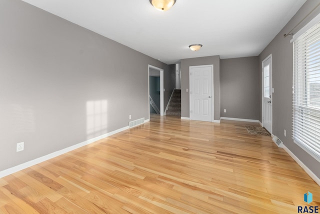 empty room with light hardwood / wood-style floors