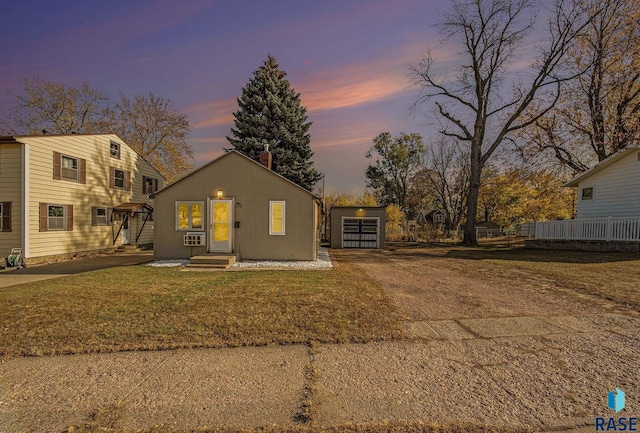 view of front facade with a lawn, an outbuilding, and cooling unit