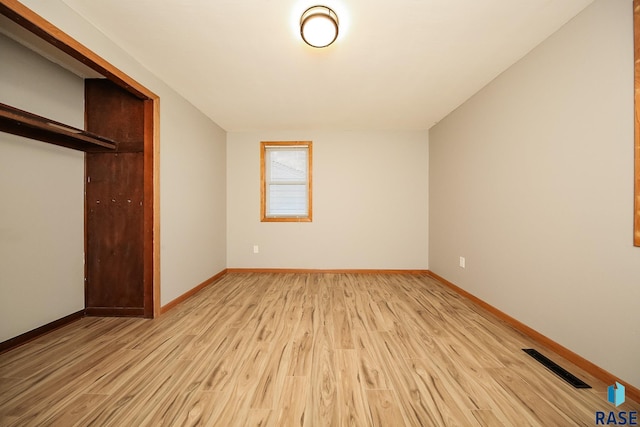 unfurnished bedroom featuring a closet and light hardwood / wood-style floors