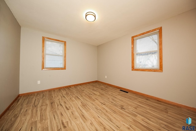 unfurnished room with light hardwood / wood-style floors