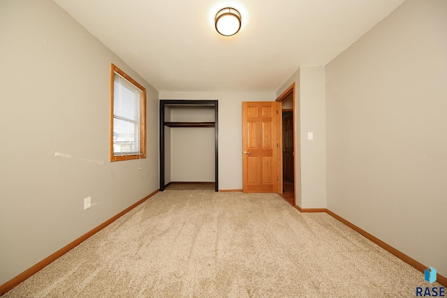 unfurnished bedroom with carpet floors and a closet