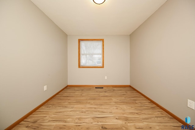 spare room featuring light hardwood / wood-style floors