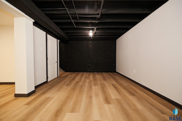 basement with light hardwood / wood-style floors