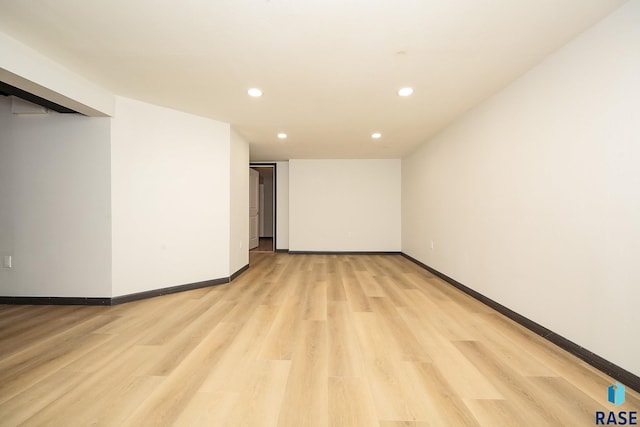 basement with light hardwood / wood-style flooring