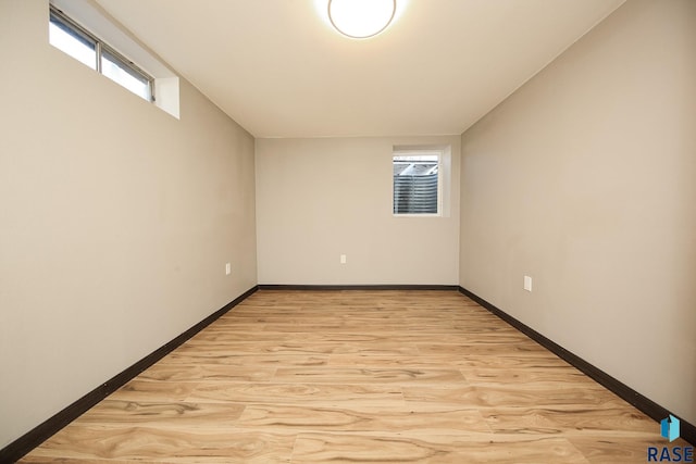 empty room featuring a wealth of natural light and light hardwood / wood-style flooring