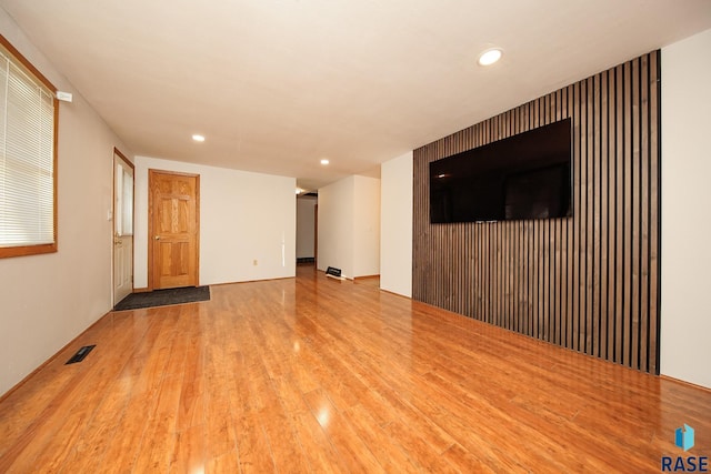 unfurnished living room featuring wood-type flooring