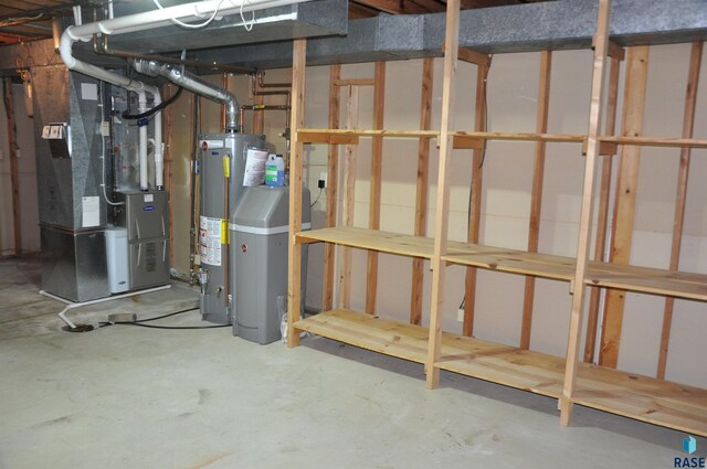 basement featuring water heater and heating unit