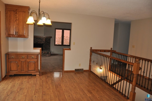 interior space featuring light hardwood / wood-style flooring and a notable chandelier