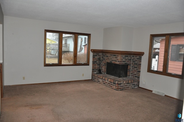 unfurnished living room featuring carpet and a fireplace