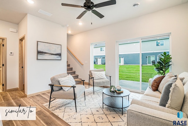 living room with ceiling fan and light hardwood / wood-style flooring