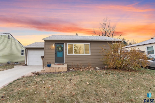 view of front of home featuring a lawn and a garage