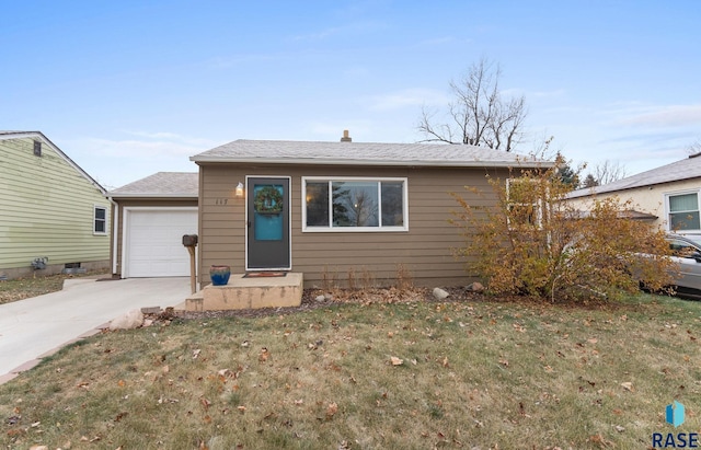 bungalow-style house with a garage and a front lawn