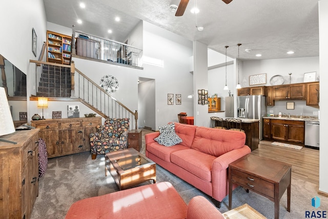 living room with high vaulted ceiling, sink, ceiling fan, dark hardwood / wood-style floors, and a textured ceiling