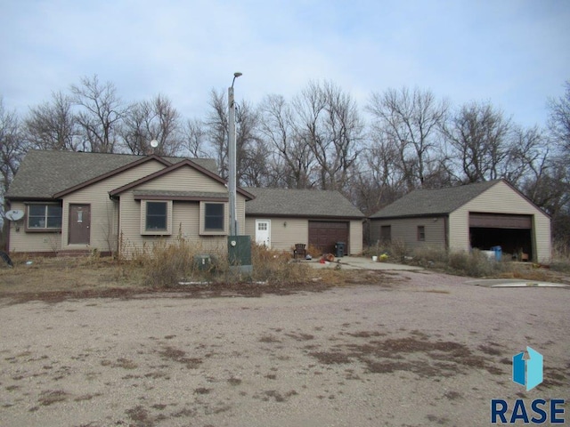 view of front of property featuring an outbuilding and a garage