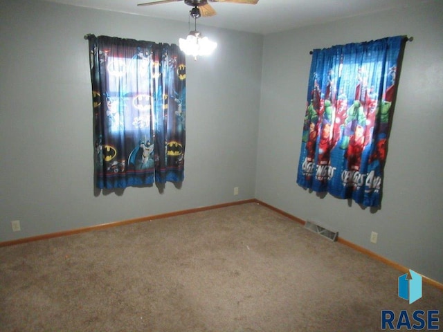 carpeted empty room with ceiling fan