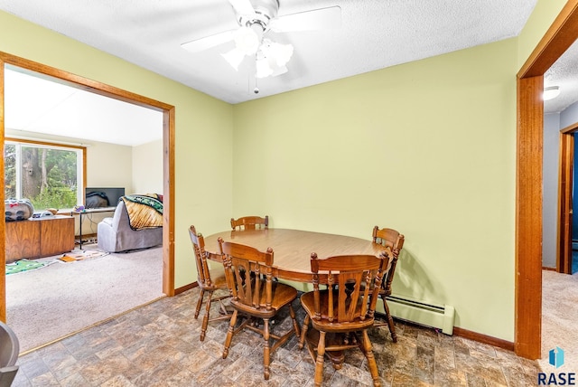 carpeted dining room with ceiling fan, a textured ceiling, and a baseboard heating unit