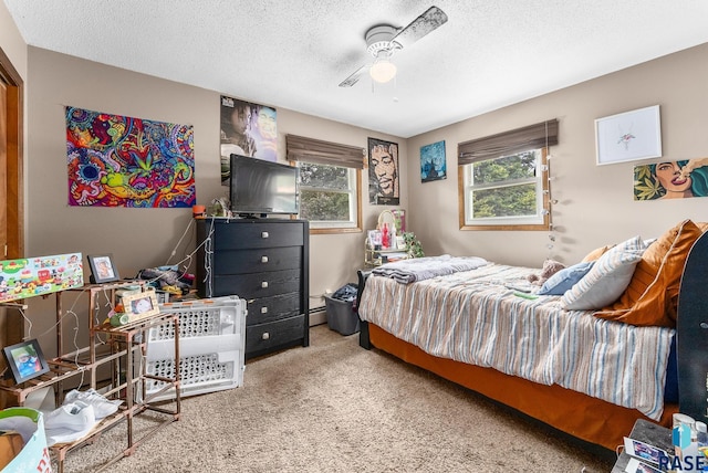 carpeted bedroom with ceiling fan and a textured ceiling