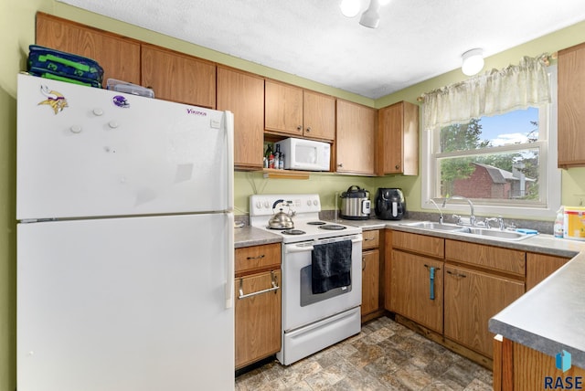 kitchen featuring sink and white appliances