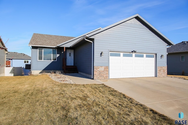 view of front of property featuring a garage and a front lawn