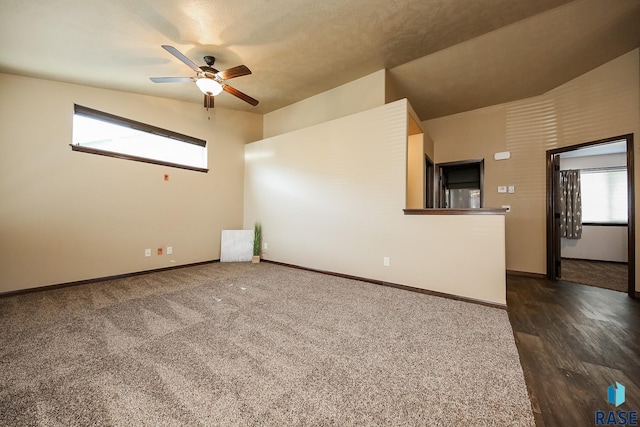 empty room featuring ceiling fan and lofted ceiling