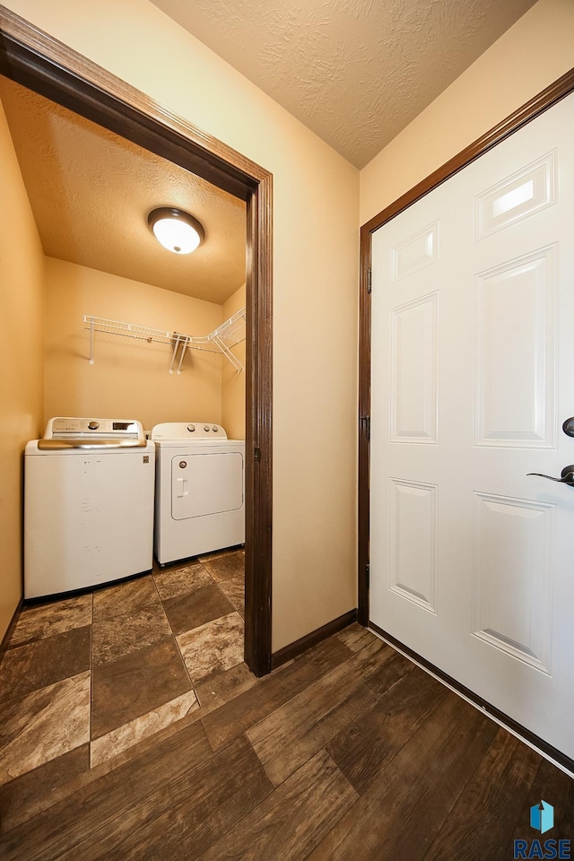 laundry room with washing machine and dryer and a textured ceiling