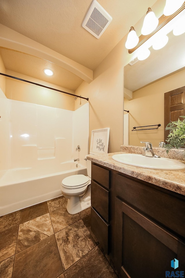 full bathroom featuring toilet, vanity, and bathing tub / shower combination