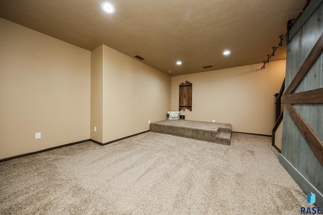 interior space featuring a barn door and carpet floors