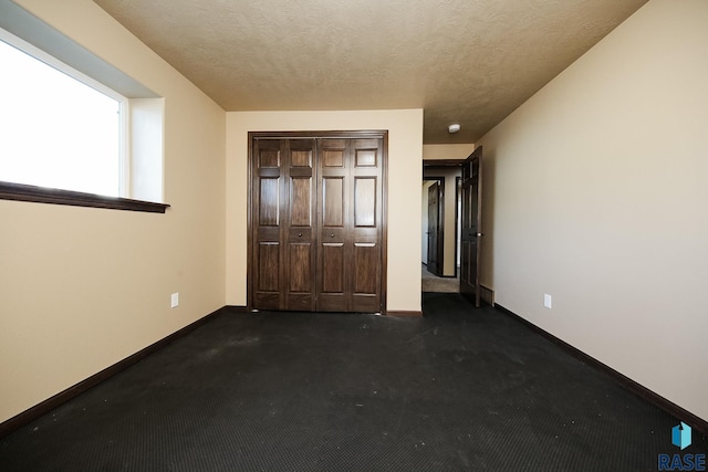 unfurnished bedroom with a closet and a textured ceiling